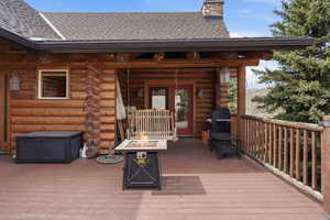 Wooden deck featuring an outdoor fire pit