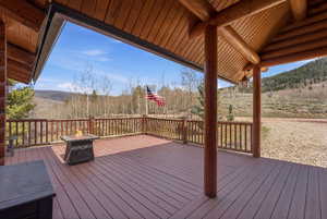Wooden deck featuring an outdoor fire pit