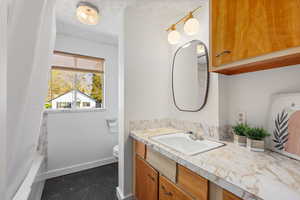 Bathroom featuring vanity and a textured ceiling