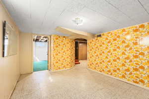 Finished basement featuring baseboards and light floors