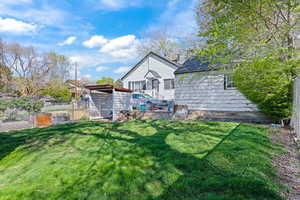 Back of house featuring an outdoor structure