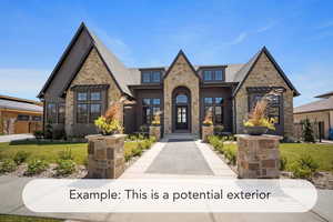 View of front of property with stone siding, a front lawn, and roof with shingles