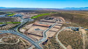 Aerial view of sparsely populated area with mountains and a desert landscape