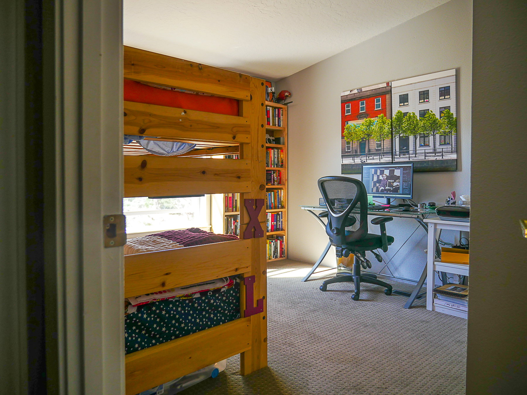 Bedroom with a desk and light colored carpet