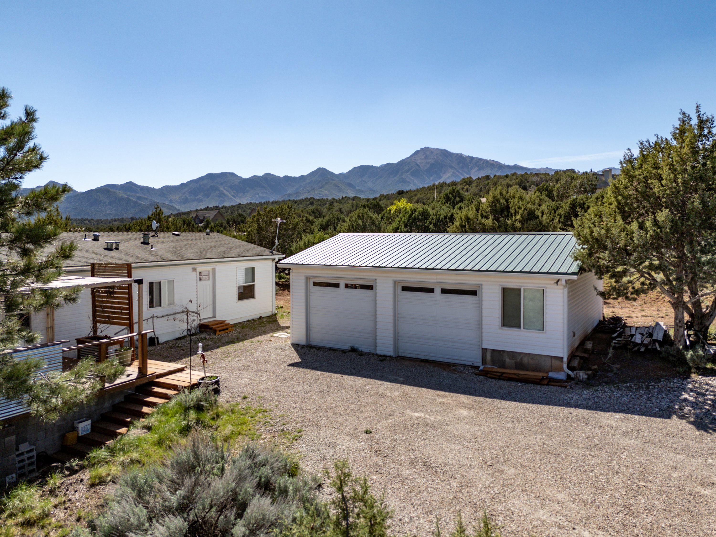 Detached garage with a mountain view and driveway