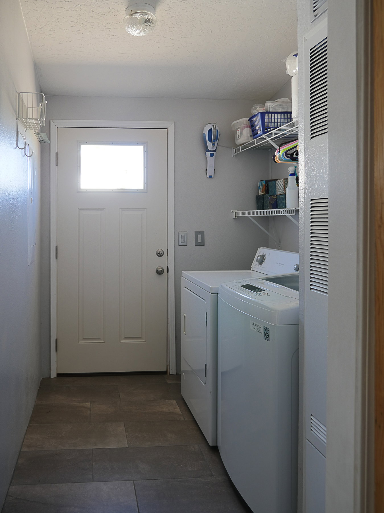 Laundry area featuring a heating unit and washer and clothes dryer