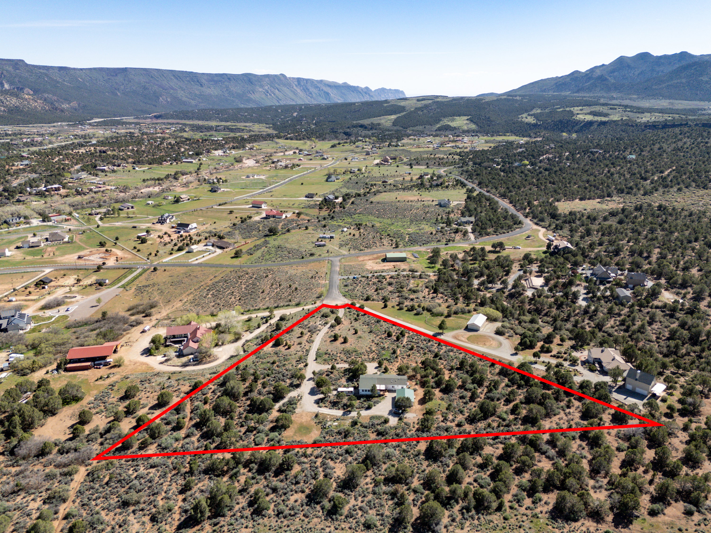 View of rural area with a mountainous background and property boundaries highlighted