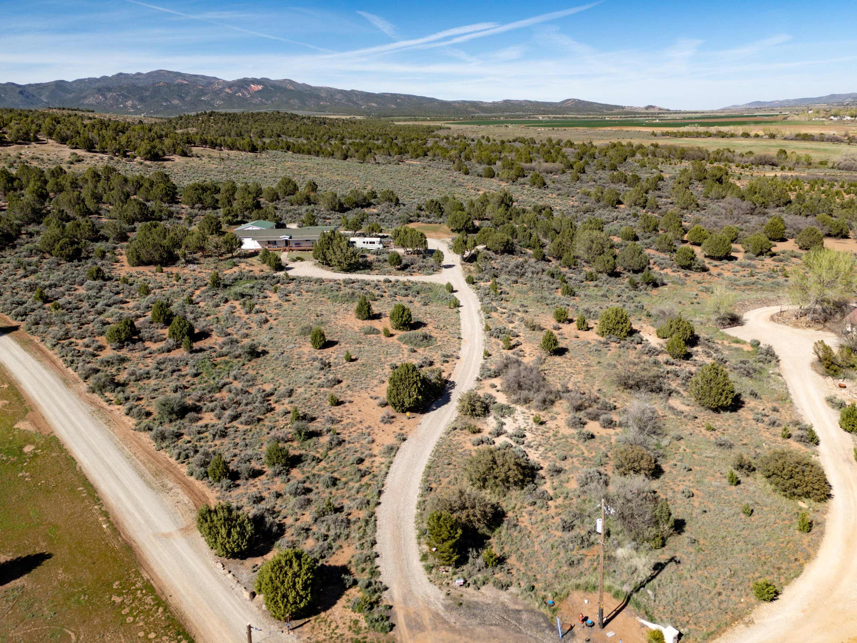 View of rural area with a mountain backdrop and a desert landscape