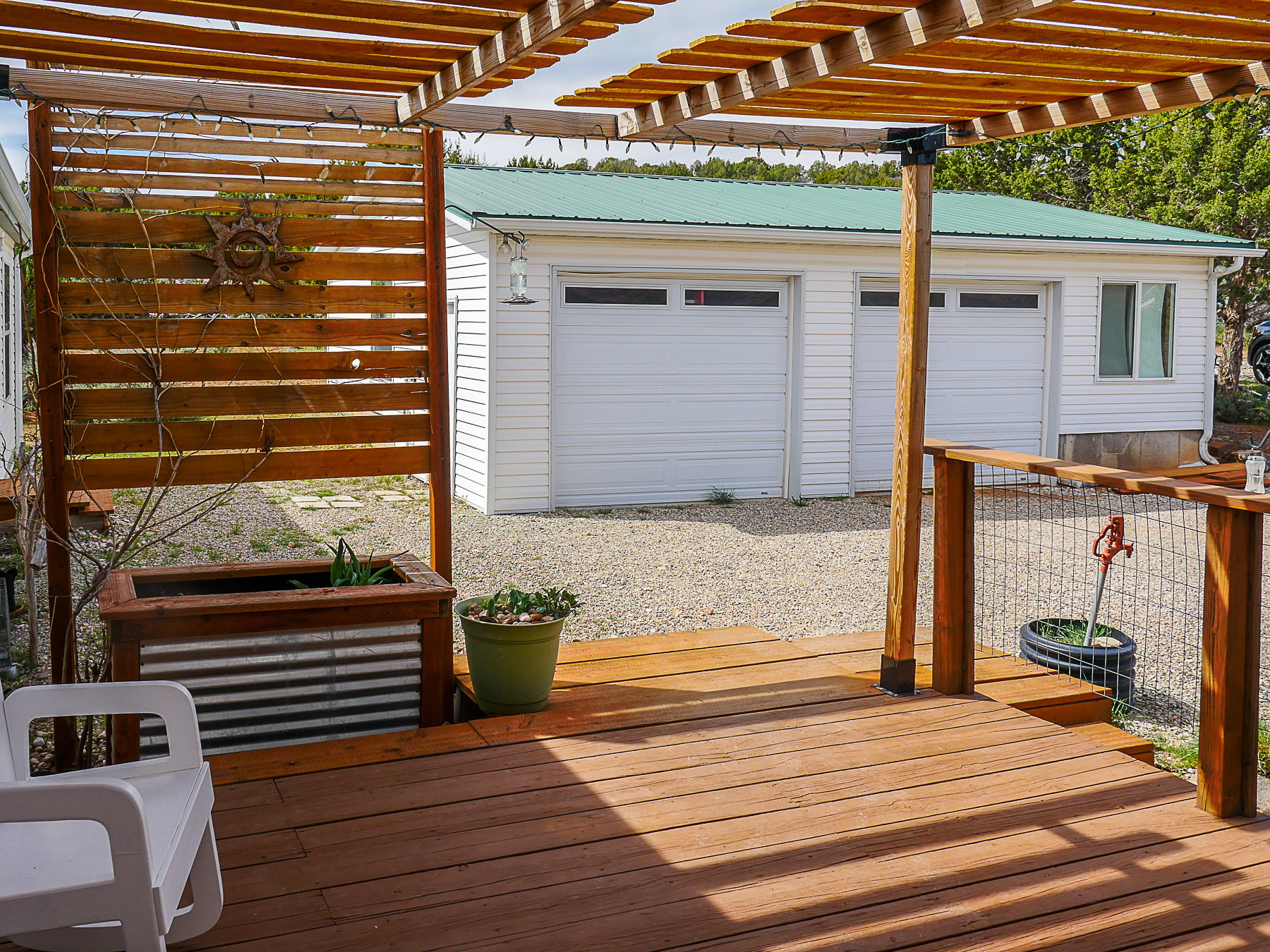 Deck with a garage and an outdoor structure