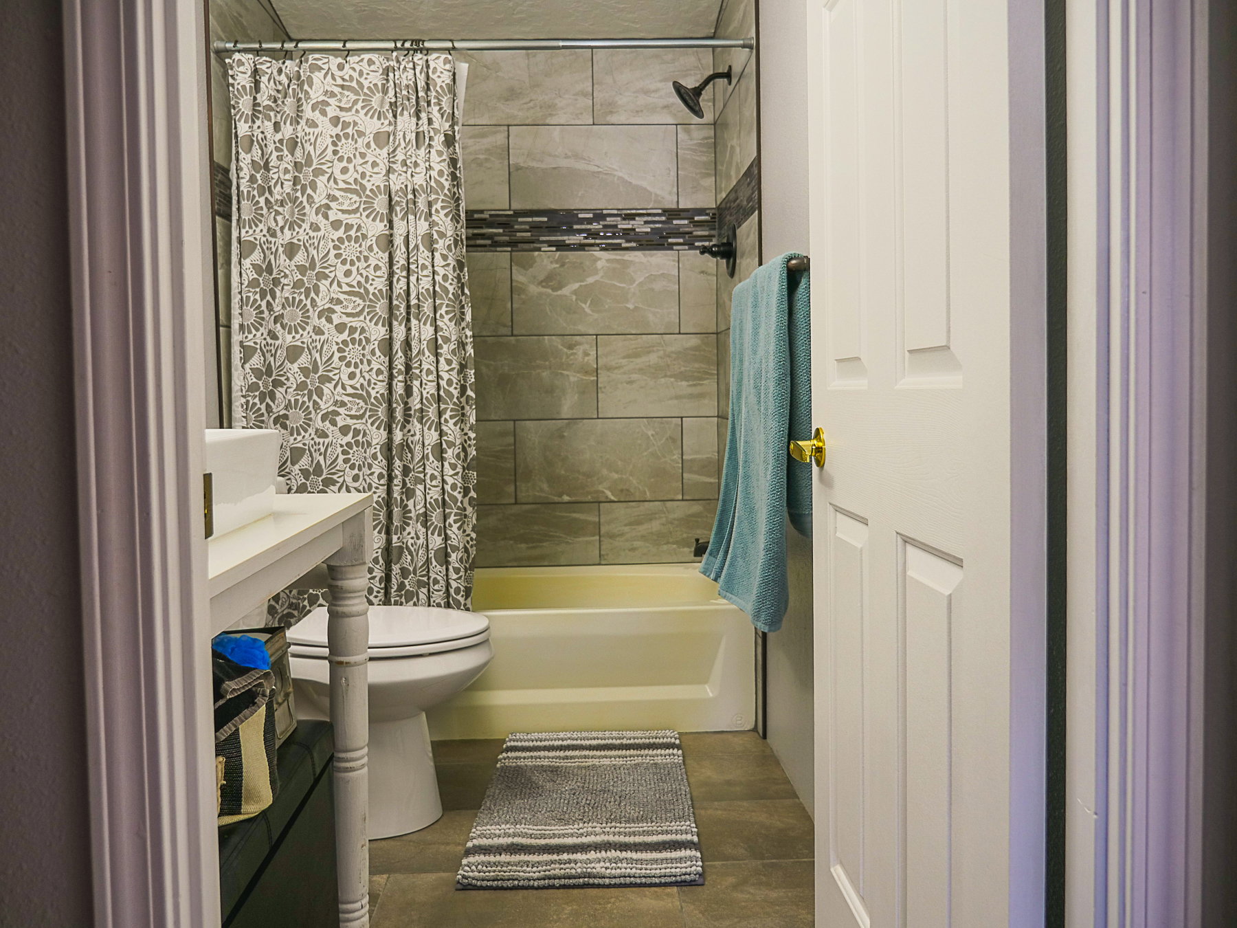 Bathroom featuring shower / bath combination with curtain and vanity