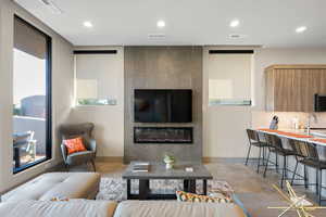 Living room with recessed lighting and concrete flooring