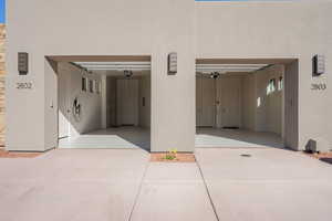Garage with car charger and concrete driveway