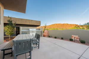 View of patio / terrace featuring outdoor dining space, a mountain view, and area for grilling