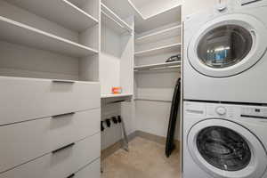 Laundry area featuring stacked washer and clothes dryer
