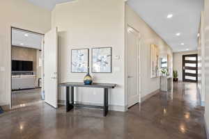 Hall with recessed lighting and finished concrete flooring