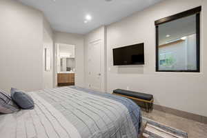 Bedroom with ensuite bath and recessed lighting