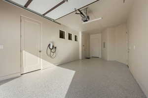 Garage featuring car charger and a garage door opener