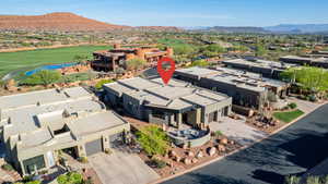 Aerial view of residential area featuring a golf course and a water and mountain view