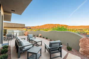 View of patio featuring an outdoor kitchen with living area and a mountain view
