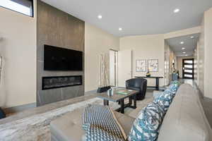 Living room with recessed lighting and a fireplace