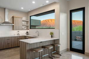 Kitchen featuring a kitchen breakfast bar, a peninsula, modern cabinets, light stone countertops, and open shelves