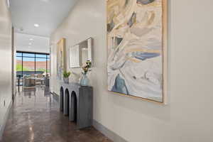 Corridor featuring baseboards and recessed lighting