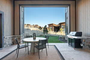 View of patio featuring outdoor dining area, grilling area, and a residential view