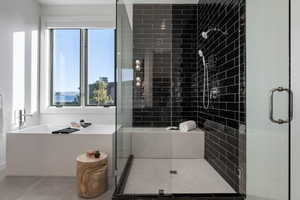 Full bathroom featuring a freestanding tub and a stall shower
