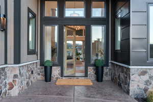 Doorway to property with stone siding