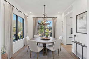 Dining space with wood finished floors and suspended lighting