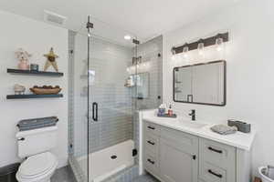 Full bathroom featuring vanity and a shower stall
