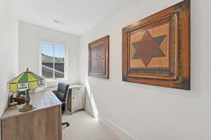 Office area featuring baseboards and light colored carpet