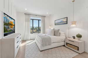 Bedroom with light wood-style flooring and recessed lighting