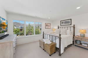 Bedroom with a mountain view, light colored carpet, and recessed lighting