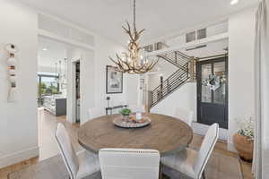 Dining room featuring light wood-style floors and a chandelier