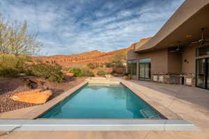 View of swimming pool featuring patio surround and a mountain view