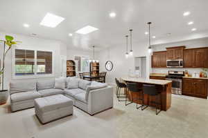 Living area with a skylight and suspended lighting