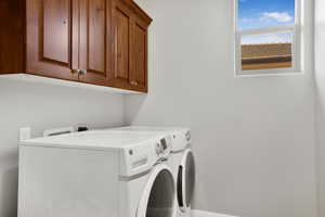 Laundry area with cabinet space and washer and dryer