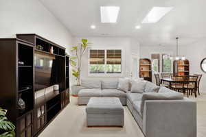 Living area with a skylight and hanging lights