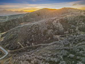 View of mountain backdrop featuring a heavily wooded area