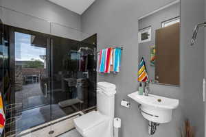 Bathroom with toilet and a stall shower