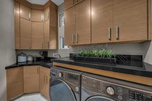 Laundry area with cabinet space and washing machine and dryer