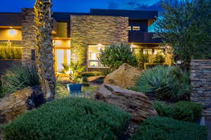 Contemporary home featuring stone siding and stucco siding