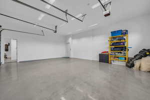 Garage featuring a central vacuum unit and a garage door opener