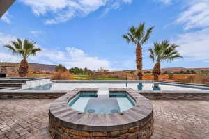Integrated pool / hot tub featuring a patio