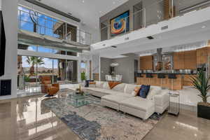 Living area with a high ceiling and recessed lighting
