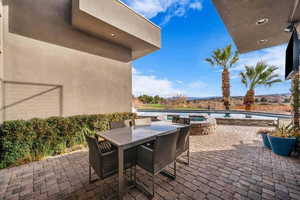 View of patio / terrace with outdoor dining space and a pool with connected hot tub
