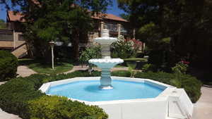 View of pool with patio surround and a balcony