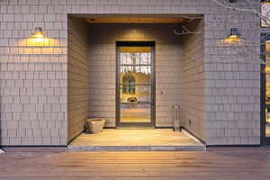 View of exterior entry featuring a wooden deck