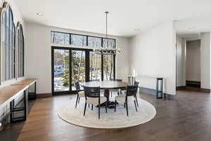 Dining area featuring recessed lighting, dark wood-style flooring, and a chandelier